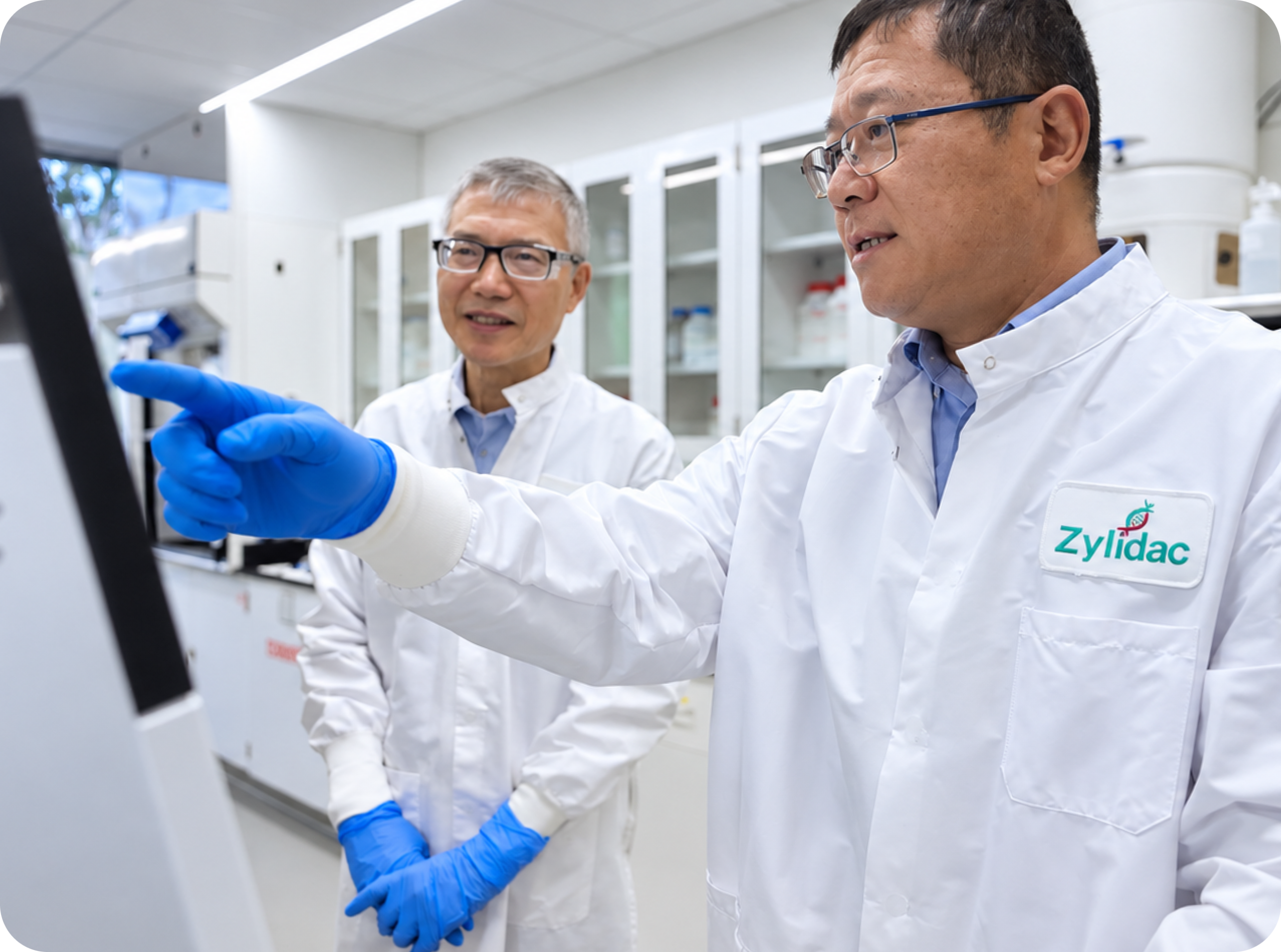 Two scientists reviewing process information on laboratory equipment